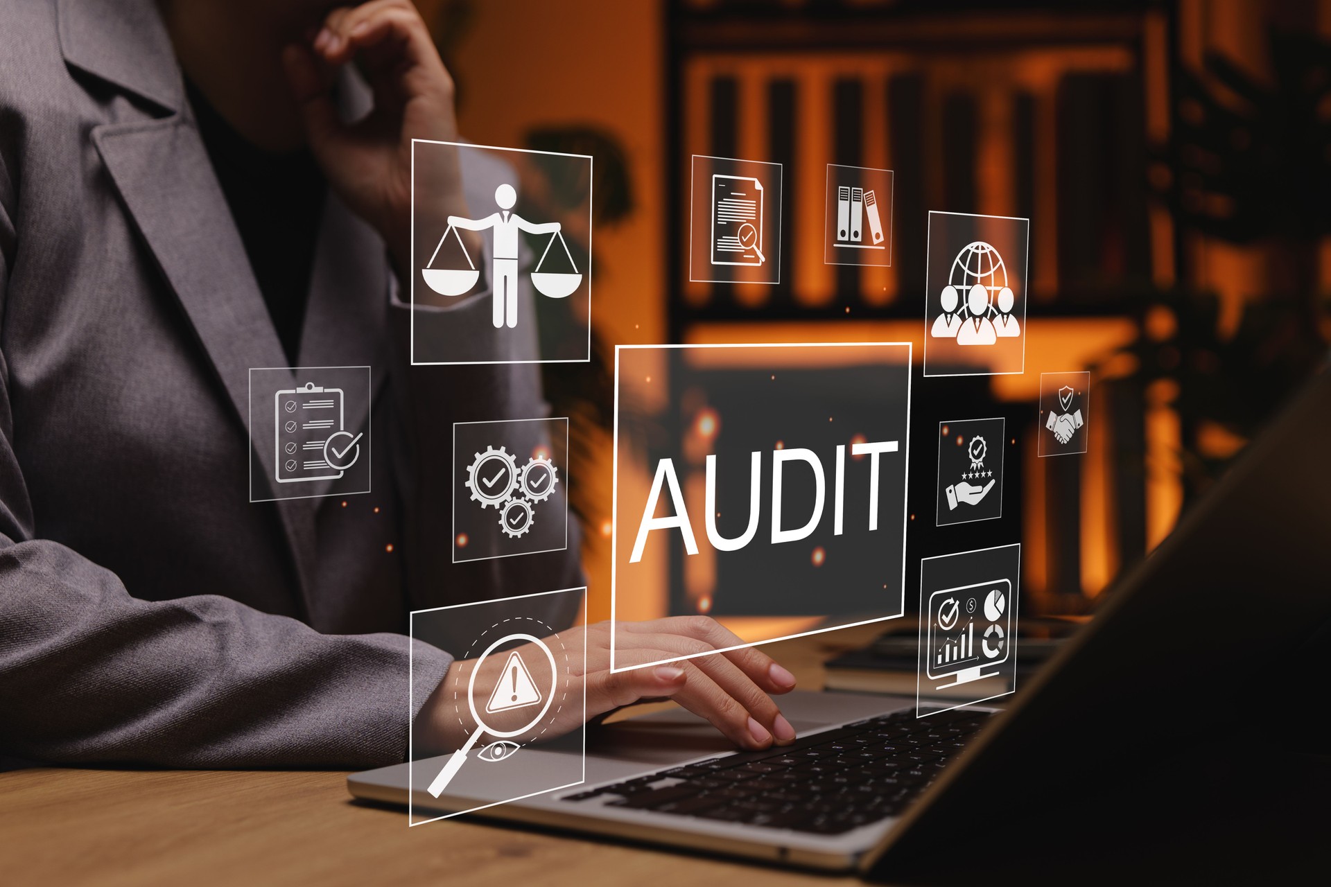 Business audit and compliance concept. Business professional working on laptop with audit and compliance icons, representing financial auditing, risk management, quality control, corporate governance,